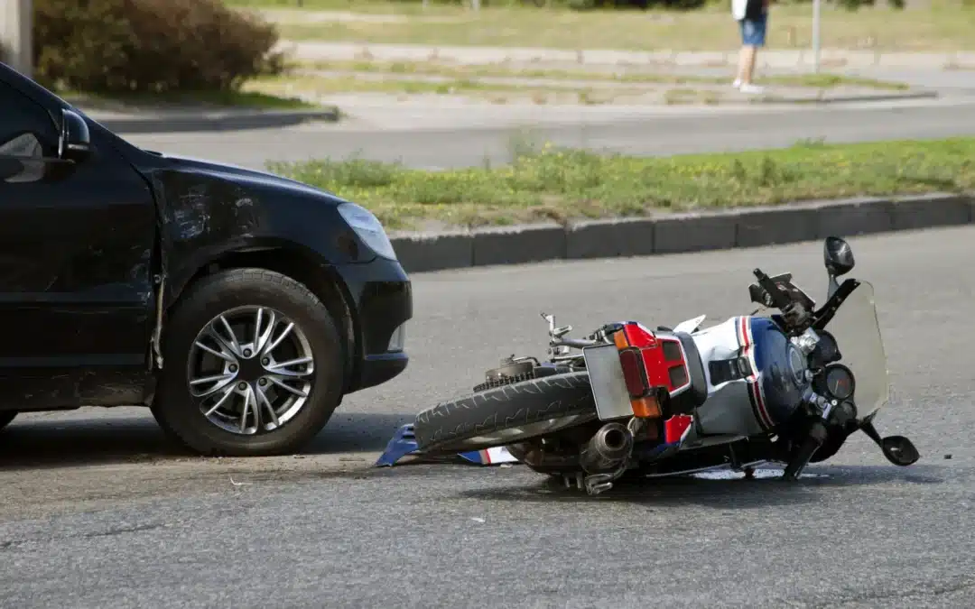 Car and motorcycle accident on road